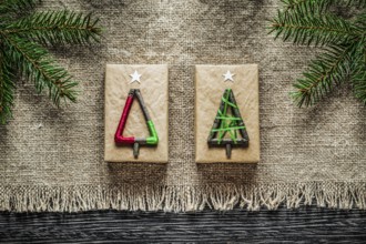 Vintage sacking pine branch Christmas gift box on wooden board