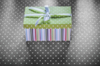 Present box on red tablecloth horizontal image celebrations concept