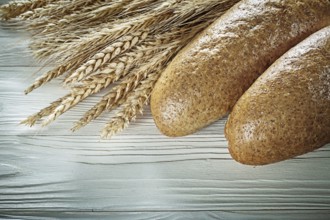 Bread stick wheat ears on white board