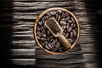 Ground coffee crops bowl scoop on wooden board
