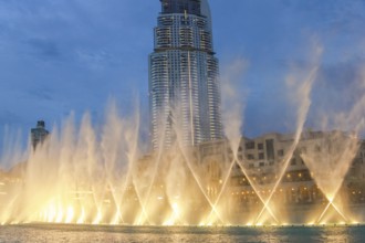 The Dancing Fountain of Dubai performs to the beat of the music at night show on lake area