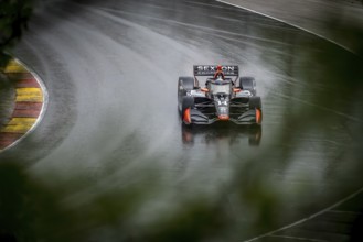 SANTINO FERRUCCI (14) of Woodbury, Connecticut comes through turn 12 (Canada Corner) during a wet