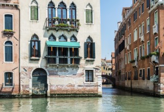 Ancient buildings in Venice. Boats moored in the channel. View from the side of the water