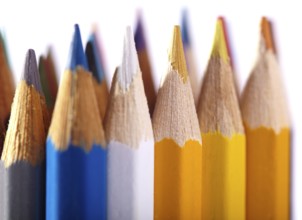 Macro shot of the color pencils isolated on white background. Artist's stuff