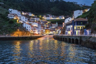 Picturesque reflection in sea water. Evening twilight in Cudillero. The village is an amphitheater