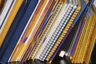 Various notebooks and books on shelf background