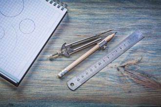 Checked copybook ruler divider pencil on vintage wood board