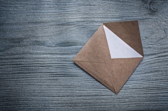 Vintage opened envelope with message on wooden board