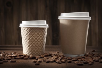 Hot Fresh Brewed Flavored Coffee. Two Classic Brown Papercups. On Vintage Wooden Background With