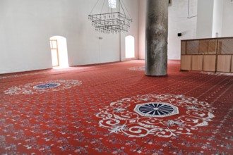 Interior of a mosque with red prayer rug and patterns, journey to Aphrodisias, Turkey