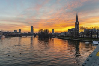 View across the River Main to the ECB and the Protestant Church of the Epiphany. Sunrise in the
