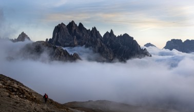Unrecognised man trekking late in the evening at the hikking path of the picturesque Dolomites at
