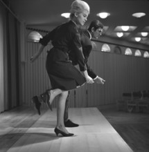 Dancing in the 1960s. The dance Hully Gully is being made popular and here are men and women