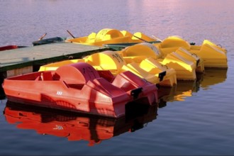 On a dock Colorful boats on a dock in a pond