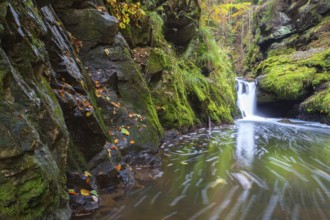 Waterfall in Doubravka valley in autumn, Highlands in Czech Republic. Autumn scenery. Long exposure