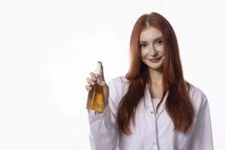 A confident woman in a lab coat showcases a nourishing oil in a professional setting, exuding