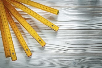 Wooden meter on white board construction concept