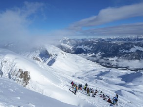 Situation on the summit of Haengst in Soerenberg, Switzerland, on a sunny winter day: A group of