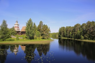 Finnish blue lake and sky landscape with UNESCO World Heritage site, old wooden church of