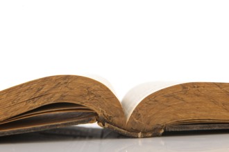 Old open book isolated over white background