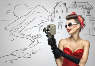 Glamorous pin up tourist girl filming a landscape with an old retro cinema 8mm camera, standing in