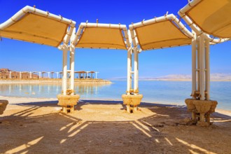 Picturesque gallery on the seashore. Coast of Israel. The drainless salt lake Dead Sea in the