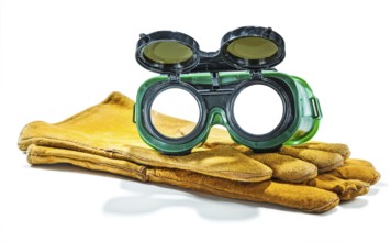 Welder working goggles on pair of gloves isolated