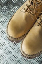 Waterproof safety boots on corrugated metal sheet
