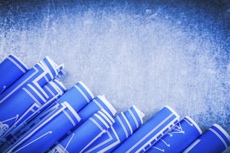 Blue construction drawings on metallic background top view maintenance concept