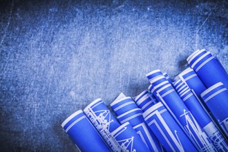 Blue blueprints on metallic background construction concept