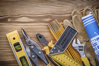 Heap of construction tooling on vintage wooden board