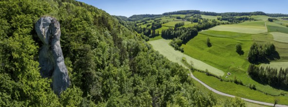 La Fille de Mai, limestone rock rising out of the forest in the Jura, drone shot, Lucelle, Jura,