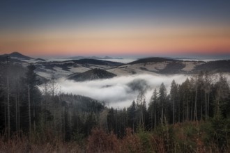 Fog over the Liptov village of Velke Borove before sunrise by Liptovska Mara in Slovakia