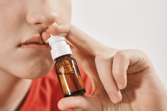 Blond Boy drips nose drops from runny nose. Treatment of colds and allergic rhinitis. Selective