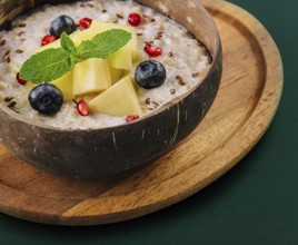 food still-life, Healthy breakfast bowl with porridge with blueberries, pineapple and pomegranate
