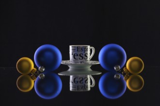 Cup of coffee and Christmas decoration on the glass table