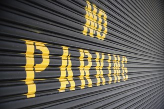 No parking - yellow sign on the garage