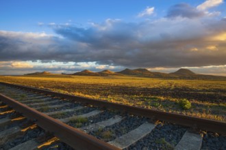 Single railway track at sunset, Central Bohemian Uplands, Czech Republic. Railway track in nature