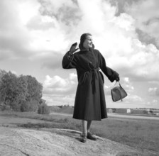 Fashionable in the 1950s. A young woman wears a typical 1950s warm coat. 1950. Ref i1699