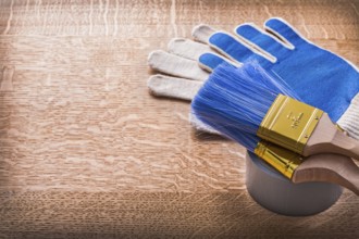 Paint brushes on duct tape and protective gloves construction concept