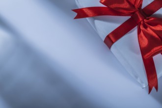 Wrapped red present box on white background