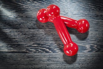 Red dumbbell weights on vintage wooden board