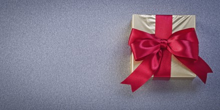 Wrapped box with presents on grey background holidays concept