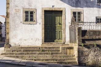 Santiago de Compostela, Spain, July 18, 2020: Old house with green wooden door in medieval town
