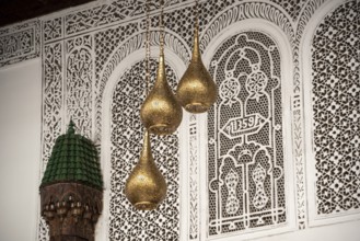 MARRAKECH, MOROCCO, ARIL 10, 2023, Three brass lamps in a typical palace in Marakesh, Morocco