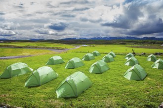 Campground in Iceland. Green tent on a grassy lawn