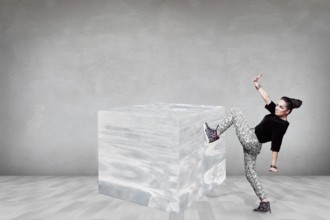 Business woman pushing big ice cube in the gray room