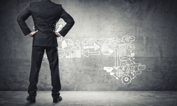 Back view of confident businessman in empty concrete room