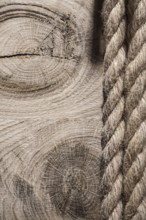 Vintage spirally twisted flax ropes on wooden board top view