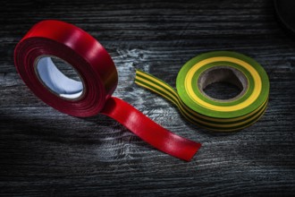 Rolled insulation tapes on vintage wooden board